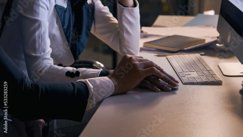 Fotografie Manager harasses his colleague a girl who works at a computer in the office