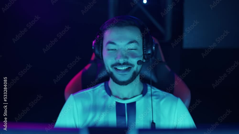 Portrait of a rejoicing gamer, plays a video game, cyber sportsman at ...