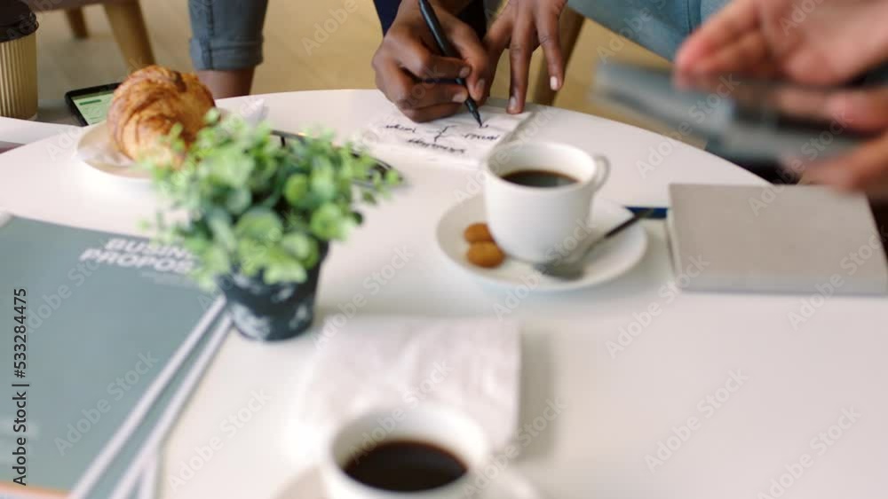 Business people, project management and design strategy in cafe, restaurant or coffee shop with digital tablet and paper. Zoom, hands or teamwork documents collaboration for company proposal strategy Business people, project management and design strategy in cafe, restaurant or coffee shop with digital tablet and paper. Zoom, hands or teamwork documents collaboration for company proposal strategy