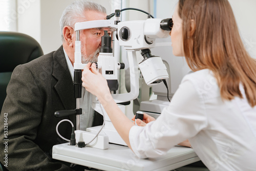 Fototapeta ophthalmologist examination of elderly man with slit lamp