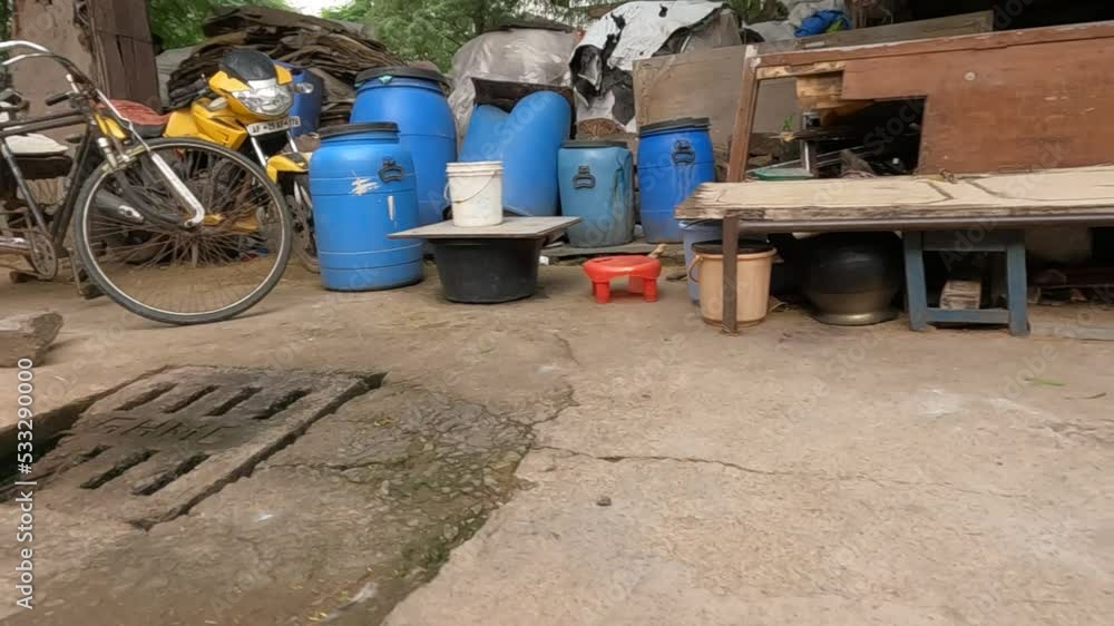 Drinking water filled in blue containers in slum area Drinking water filled in blue containers in slum area