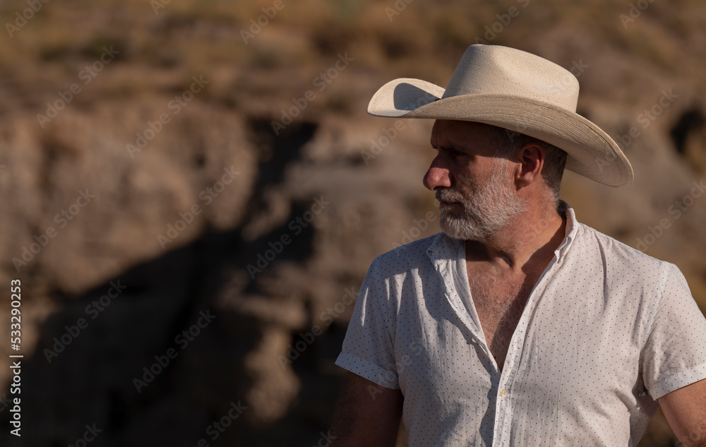 Adult man in cowboy hat in desert. Almeria, Spain