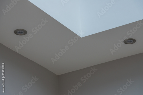 White ceiling bulkhead with Led down lights and grey wall.