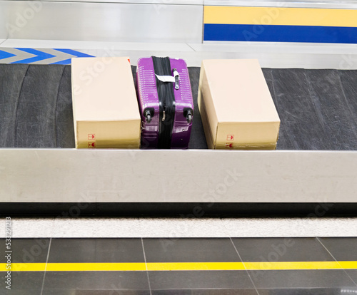 Group of suitcases on conveyor belt of airport photo