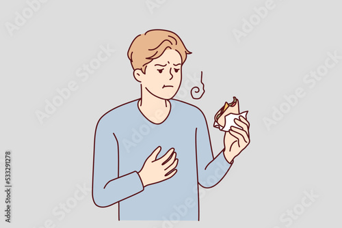 Unwell young man feel bad eating sandwich. Unhealthy guy have indigestion or food poisoning after snack. Stomachache problems. Vector illustration.  photo