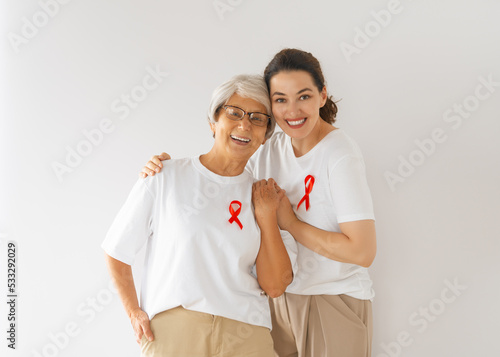 Smiling women with red satin ribbon photo