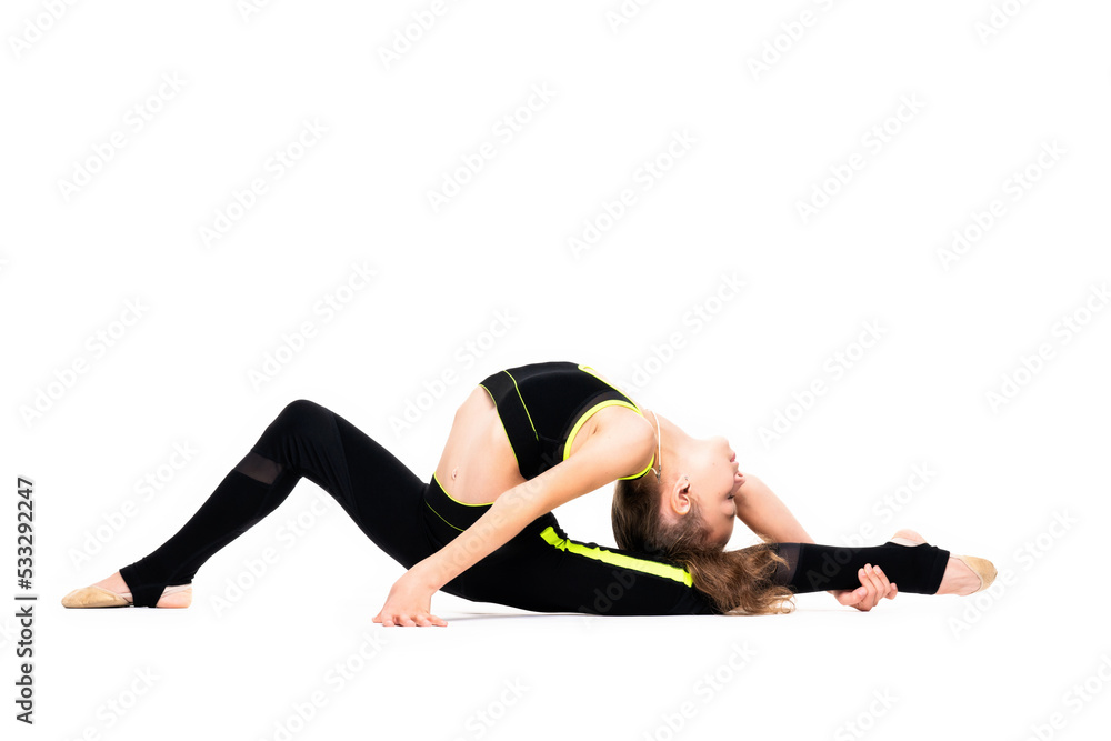 Gymnastic exercises. A flexible little girl in a black tracksuit arches her back and reaches for her leg with her hand. Stretch isolated on white background. Sport, active lifestyle concept Gymnastic exercises. A flexible little girl in a black tracksuit arches her back and reaches for her leg with her hand. Stretch isolated on white background. Sport, active lifestyle concept