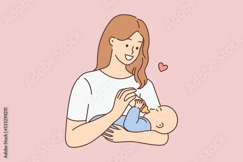 Happy woman feeding infant 