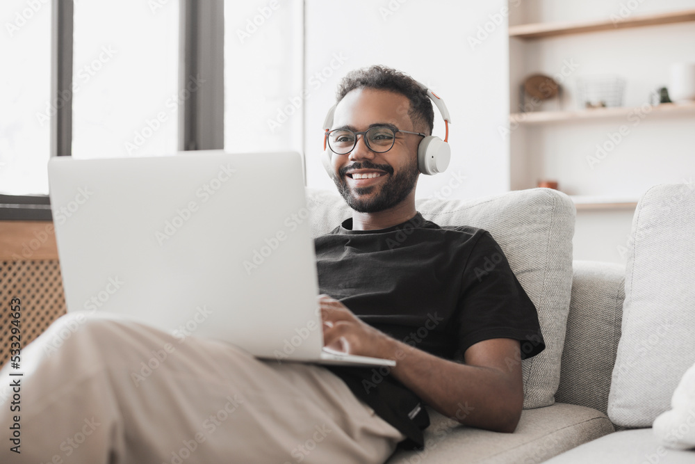 Young man using laptop computer at home, Student men resting in his room, Home work or study, freelance, online learning and communication concept Young man using laptop computer at home, Student men resting in his room, Home work or study, freelance, online learning and communication concept