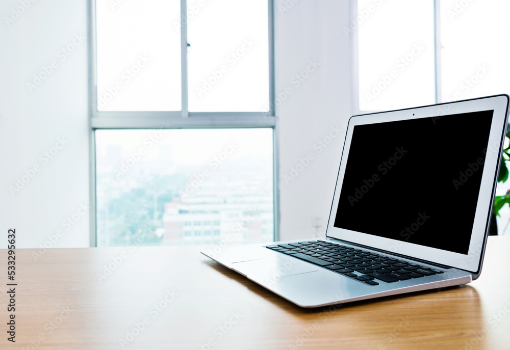 Sinlge laptop on table in office Sinlge laptop on table in office