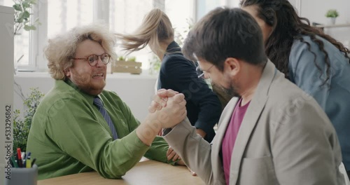 Wallpaper Mural Funny chubby guy is arm wrestling with coworker in office winning having fun in workplace together. Corporate activities and youth lifestyle concept. Torontodigital.ca