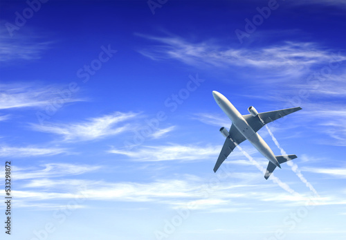 Horizontal nature background with aircraft and Jet trailing smoke in the sky. Airplane and condensation trail