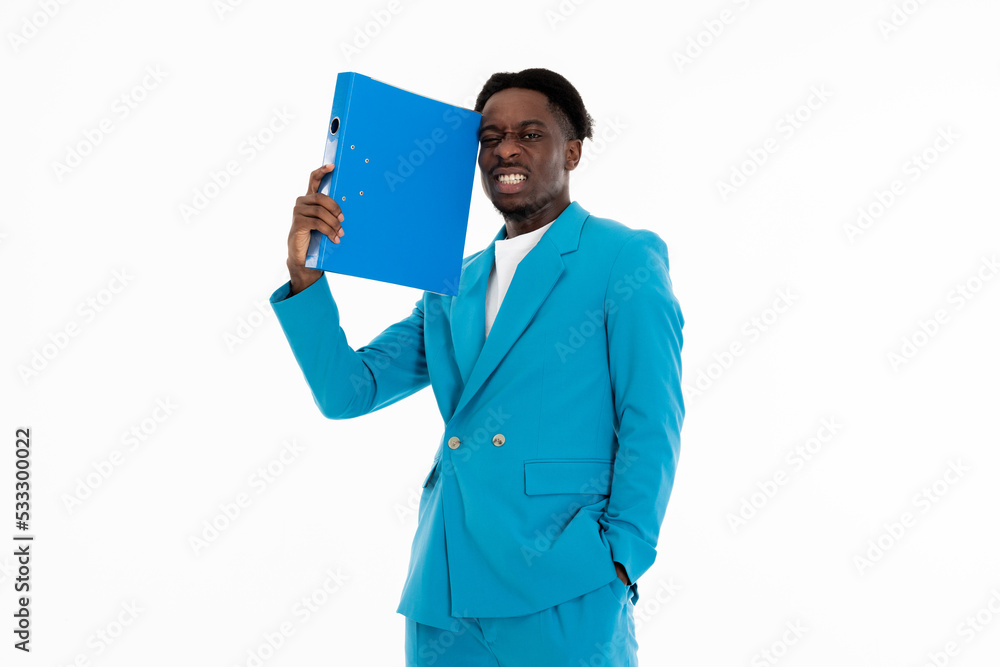 Portrait of african american man holding folder in arm showing angry emotions at camera posing in blue suit and white t-shirt standing on white background in studio isolated. Portrait of african american man holding folder in arm showing angry emotions at camera posing in blue suit and white t-shirt standing on white background in studio isolated.