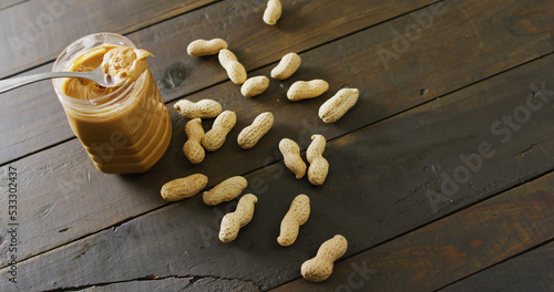 Image of close up of peanut butter on wooden background
