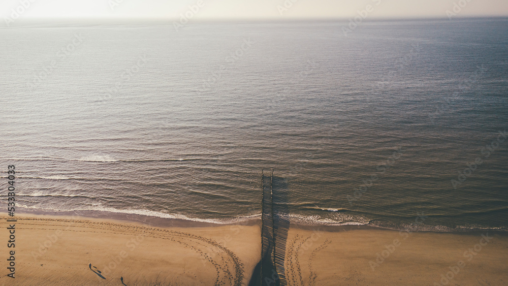 Aerial view of wooden posts at beach Aerial view of wooden posts at beach