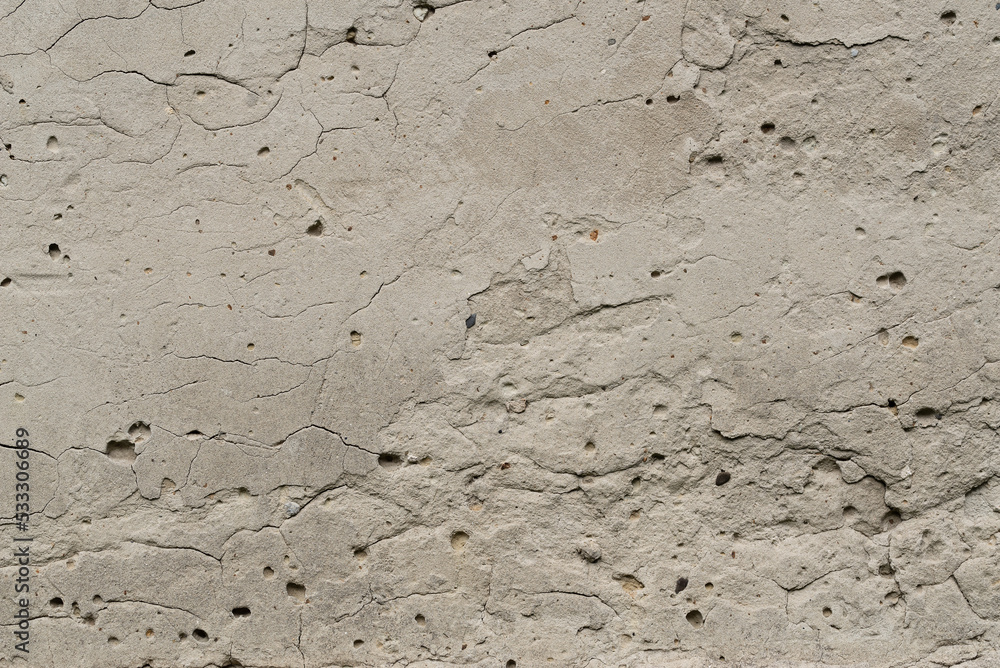 Fototapeta premium Old sandy gray plaster surface with blemishes