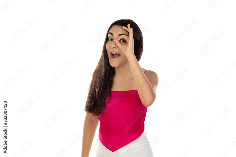 Young brunette woman looking through her fingers as they were glasses Young brunette woman looking through her fingers as they were glasses