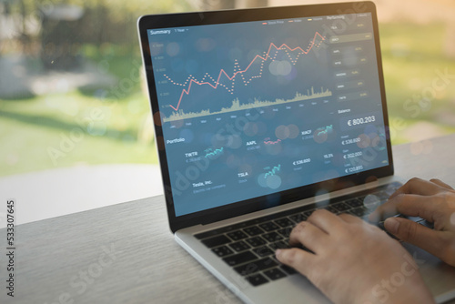 Photography Business people using Laptop with various type of financial and investment products in Bond market