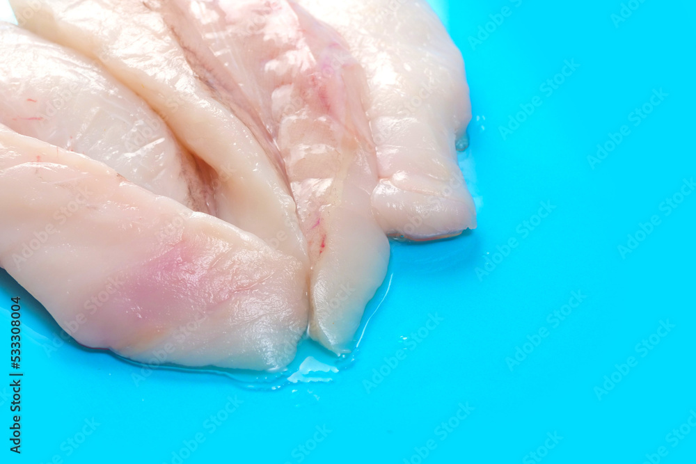 Monk fish fillets on blue ocean color surface. Seafood product with fine taste and soft tender feel. Fish monger craft. Monk fish fillets on blue ocean color surface. Seafood product with fine taste and soft tender feel. Fish monger craft.