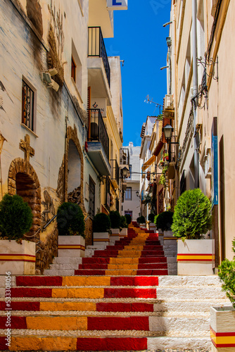  antique staircase in Calpe, Spain in the old town painted red and yellow in the color of the country's flag © Joanna Redesiuk