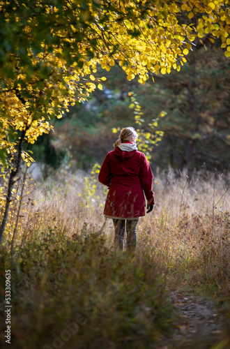 Woman walks in the park in autumn