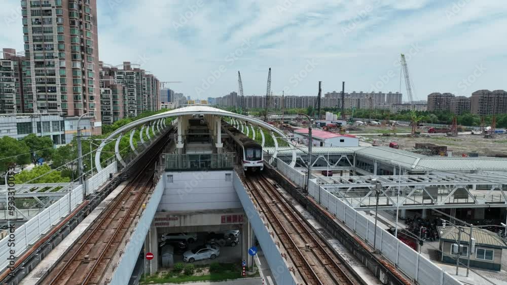 The metro station outdoor and the train in the city. Drone aerial view. The subway track and station in the city. Aerial view of the train . Transportation cityscape business concept b-roll footage. The metro station outdoor and the train in the city. Drone aerial view. The subway track and station in the city. Aerial view of the train . Transportation cityscape business concept b-roll footage.