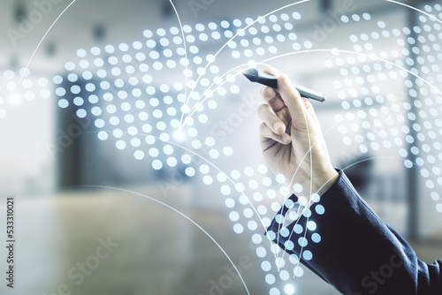 Man hand with pen working with abstract virtual world map with connections on blurred office background, international trading concept. Multiexposure