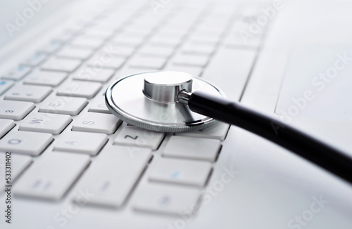 Stethoscope on the keyboard of laptop