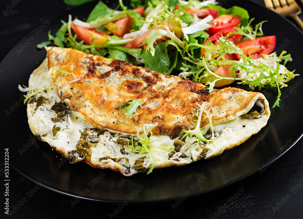 Ketogenic diet breakfast. Omelette with sorrel and tomatoes salad. Ketogenic diet breakfast. Omelette with sorrel and tomatoes salad.