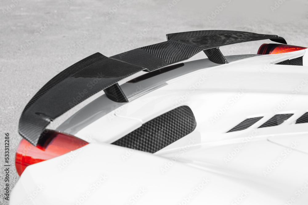 Modern supercar carbon spoiler wing at the trunk Modern supercar carbon spoiler wing at the trunk