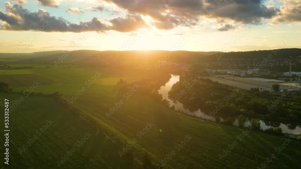 Flight above river illuminated by sunset flare Flight above river illuminated by sunset flare