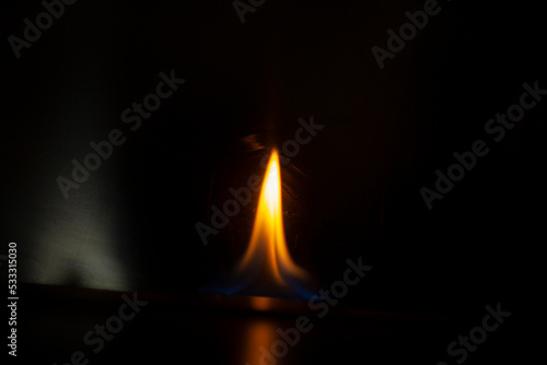 Flames in dark. Tongue of fire one. Alcohol flame retardation.