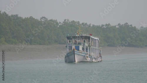 Boat Cruising Through A River In The Sundarban National Park, India photo