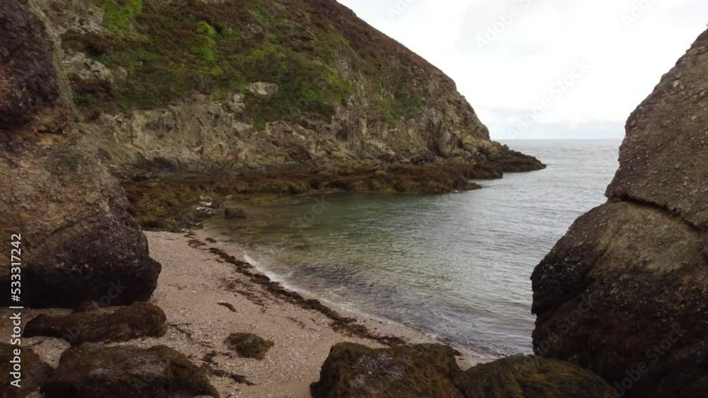 Pull Back Shot Between Two Rocks On Fabulous Beach Place, Porth Wen, United Kingdom