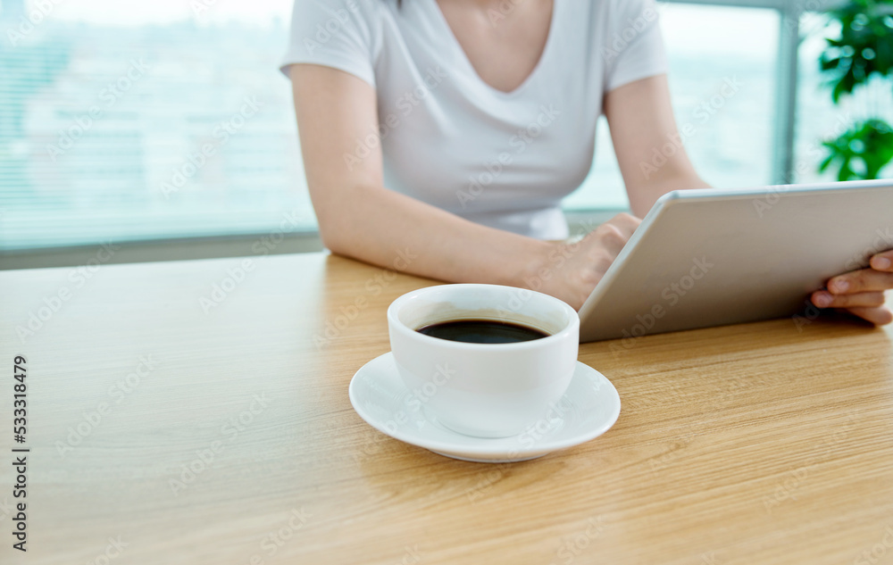 Woman using her tablet pc in cafe