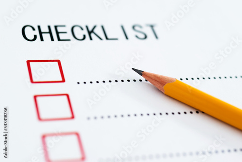Checklist box on paper with checkmark and pencil