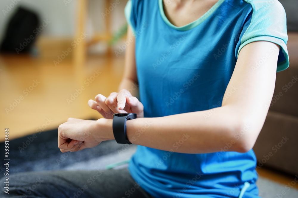 Health care, heart rate monitor, portrait of Asian beautiful woman using smart watch to select health programs such as yoga, cardio exercises, breathing meditation. to prepare before the activity Health care, heart rate monitor, portrait of Asian beautiful woman using smart watch to select health programs such as yoga, cardio exercises, breathing meditation. to prepare before the activity
