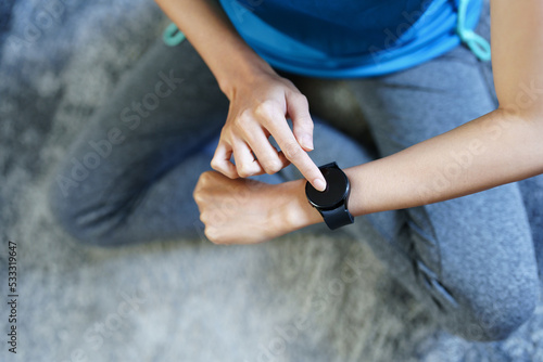 Health care, heart rate monitor, portrait of Asian beautiful woman using smart watch to select health programs such as yoga, cardio exercises, breathing meditation. to prepare before the activity