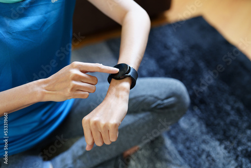 Health care, heart rate monitor, portrait of Asian beautiful woman using smart watch to select health programs such as yoga, cardio exercises, breathing meditation. to prepare before the activity