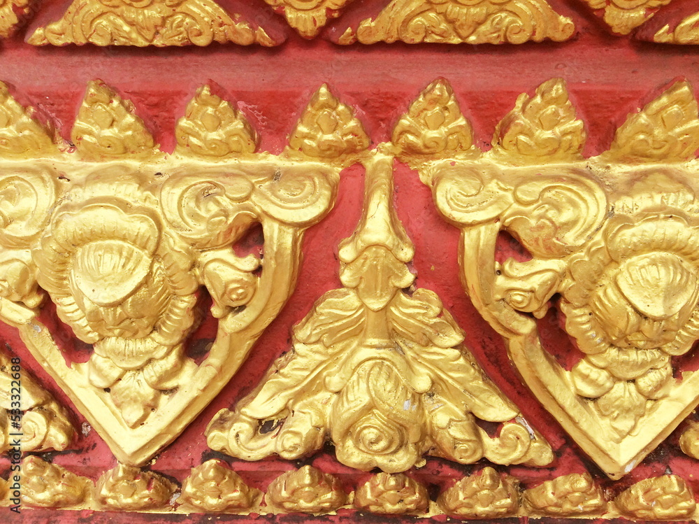 Traditional Thai style stucco on the wall of church in temple, Thailand.