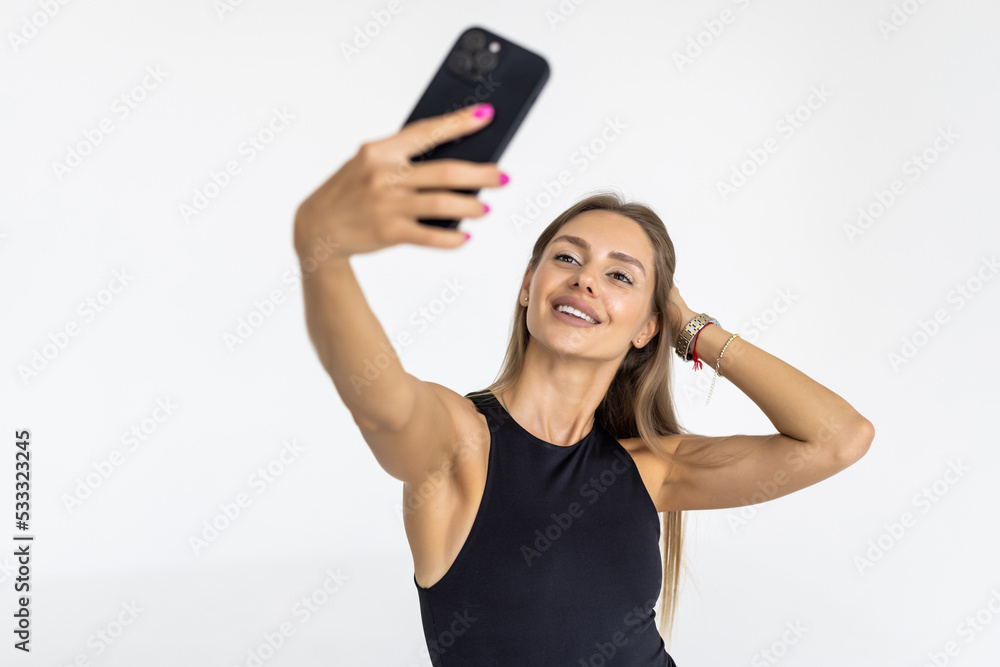 Pretty young happy woman making selfie on smartphone on white background Pretty young happy woman making selfie on smartphone on white background