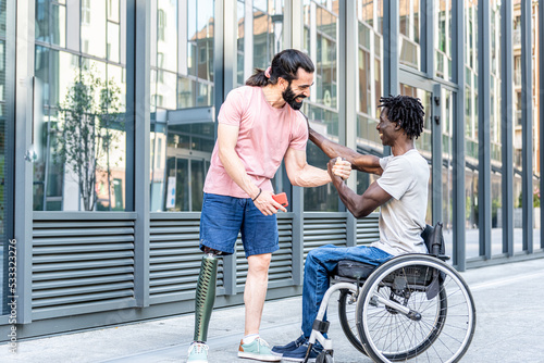 Multiracial happy friends greeting each other, people with disability having a chat outdoor