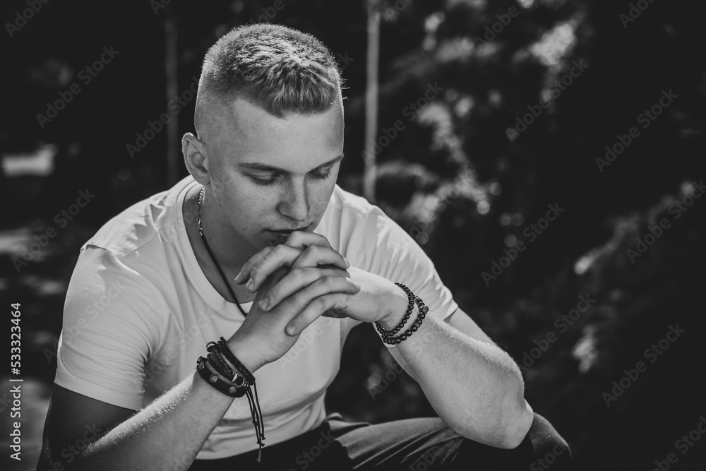 Young European student guy with a sad philosophical mood. The concept of life youth years, problems and depression. Crisis of life Young European student guy with a sad philosophical mood. The concept of life youth years, problems and depression. Crisis of life