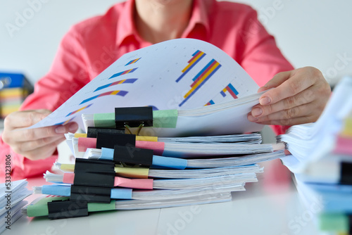 Accountant woman hands sorting business reports