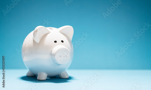 White piggy bank on blue background