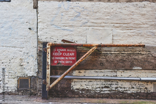 A worn gate with Keep Clear sign in London