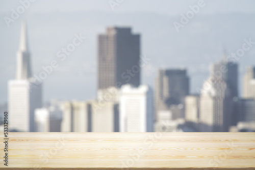 Empty tabletop made of wooden dies with blurry city view in sunny weather on background  template