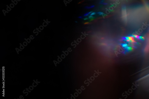 Blur colorful rainbow crystal light leaks on black background. Defocused abstract multicolored retro film lens flare bokeh analog photo overlay or screen filter effect. Glow Vintage prism colors © Aleksandra Konoplya