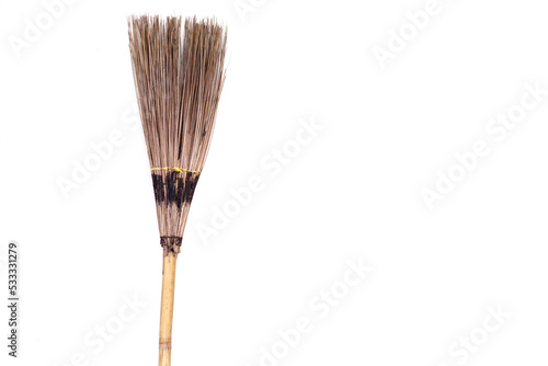 Handmade broom that made from natural materials, bamboo for handle and coconut sticks for the part of sweeping, isolated on white background. Concept : tool for cleaning. use for sweep dry leaves.