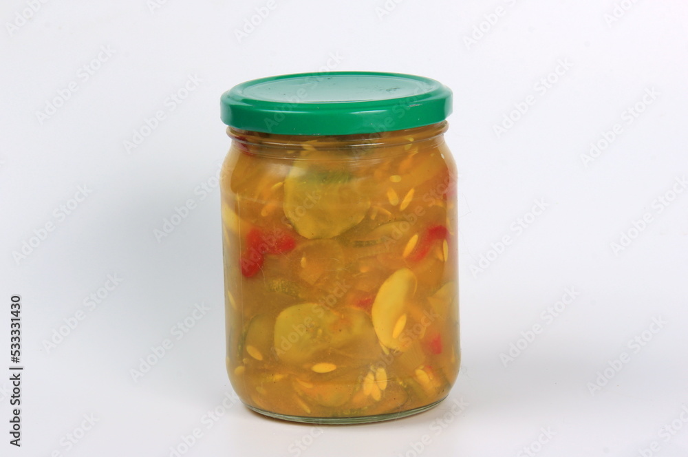 Glass jars with canned cucumber salad on a white background Glass jars with canned cucumber salad on a white background